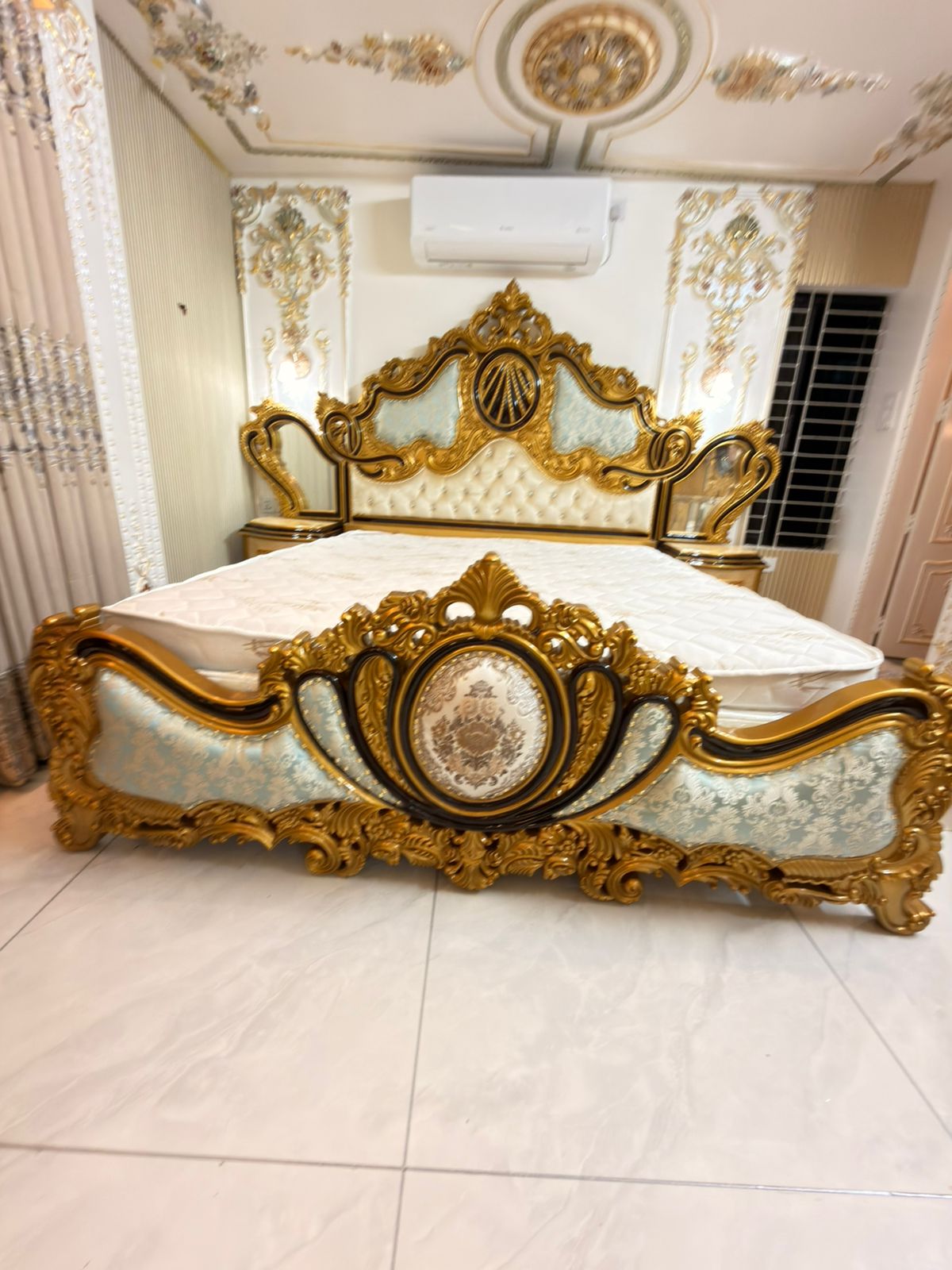 Baroque-style gold and black bed frame detail